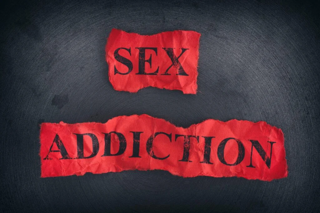 Crumpled pieces of paper with the words Sex Addiction
