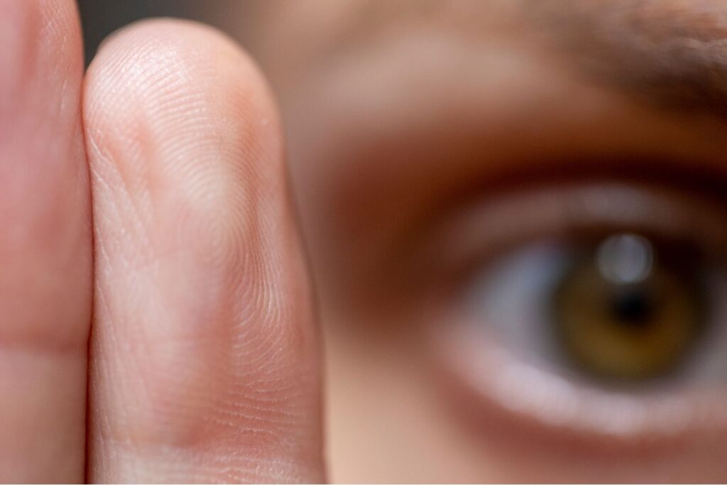 Close-up of eye and fingertip texture