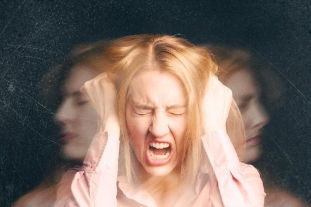 Woman screaming in frustration holding her head