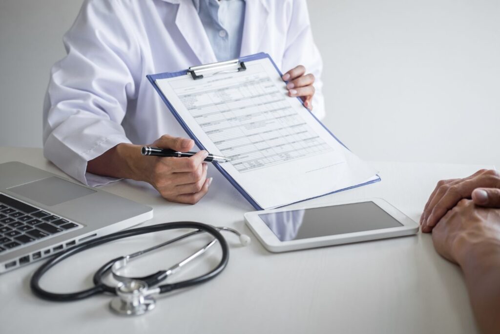 Doctor reviewing medical chart with patient