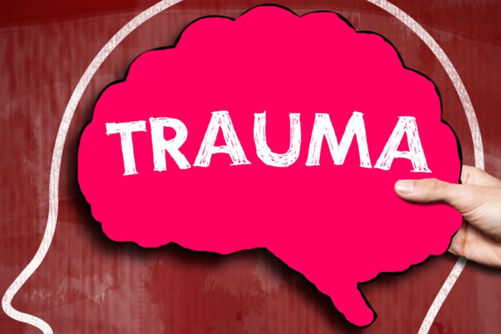 Pink brain graphic with the word trauma