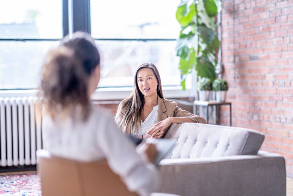 Two women talking in modern office setting