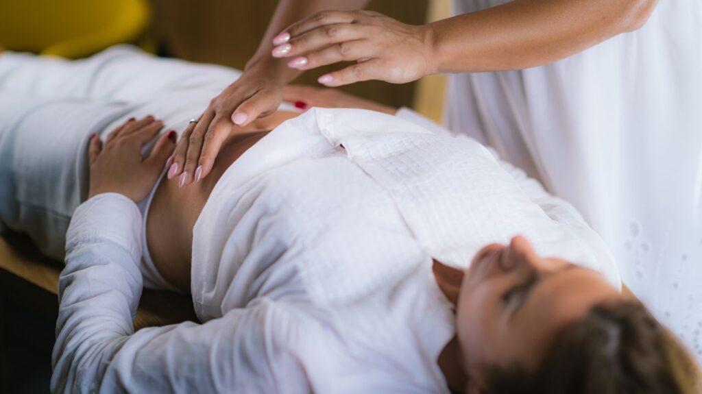 Pregnant woman receiving prenatal belly massage