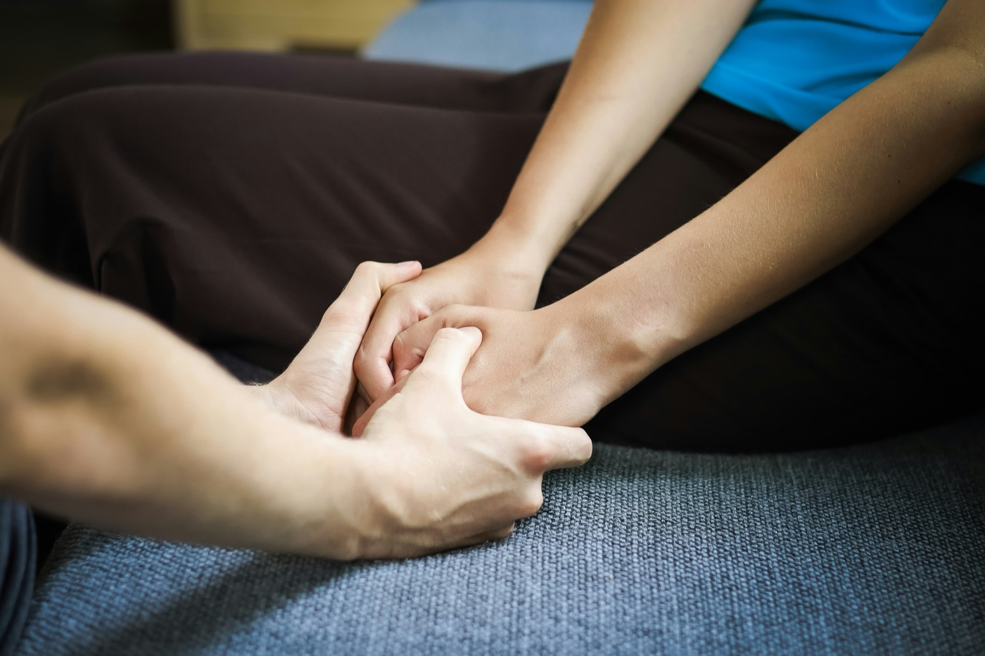 Two people holding hands in support